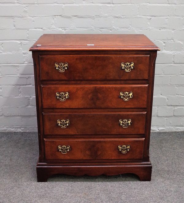 A small 18th century style walnut chest of four long drawers, flanked by canted reeded corners, 61cm wide x 74cm high.