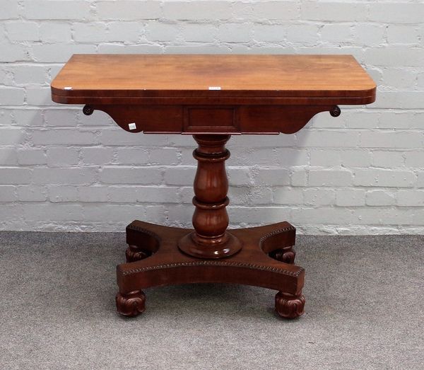 An early 19th century mahogany tea table, the foldover rectangular top on turned column and quatrefoil platform, 92cm wide x 75cm high.