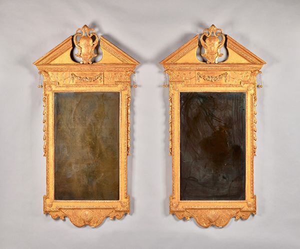 A pair of George II style gilt framed mirrors each with broken architectural cornice, centred by cartouche over rectangular plate and shell lower frie