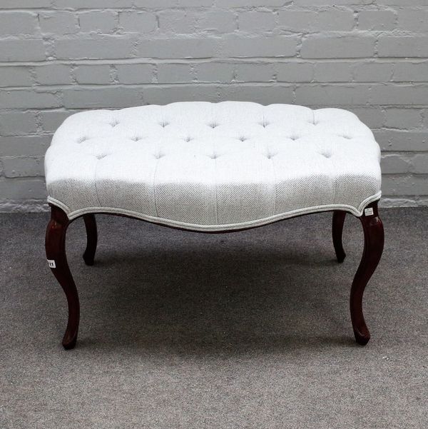 A mahogany framed footstool, with button upholstered serpentine shape top on cabriole supports, 82cm wide x 48cm high.