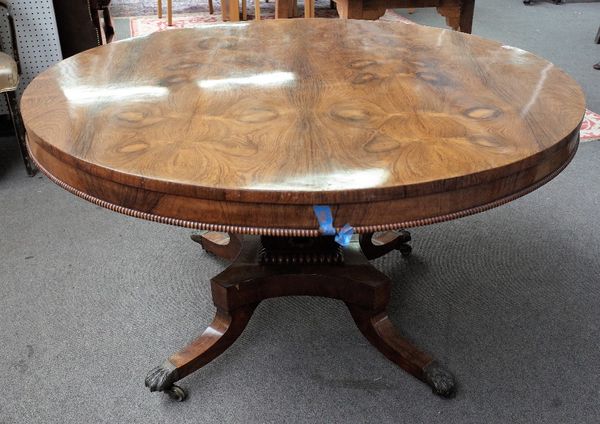 A William IV rosewood centre table, the circular snap top on foliate carved square column and four downswept supports, 127cm diameter x 74cm high.