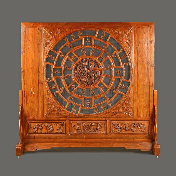 A late 19th century/ early 20th century large Chinese carved softwood room divider, relief carved with fighting warriors within a geometric circular b