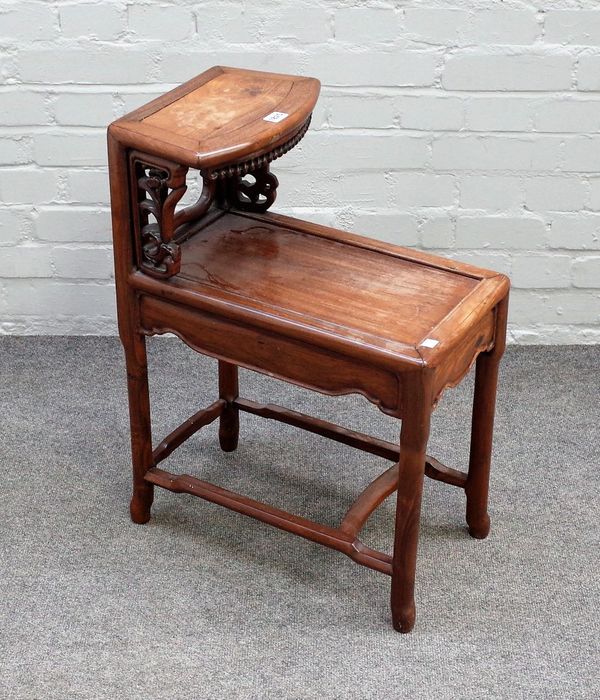 An early 20th century Chinese hardwood two tier side table, with pierced  decoration, on turned supports, 49cm wide x 67cm high.