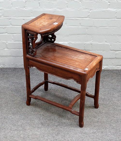An early 20th century Chinese hardwood two tier side table, with pierced  decoration, on turned supports, 49cm wide x 67cm high.