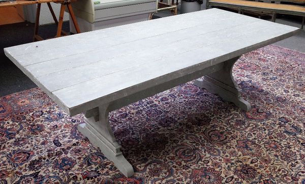 A Swedish grey painted rectangular kitchen table on shaped trestle end standards, 100cm wide x 219cm long.