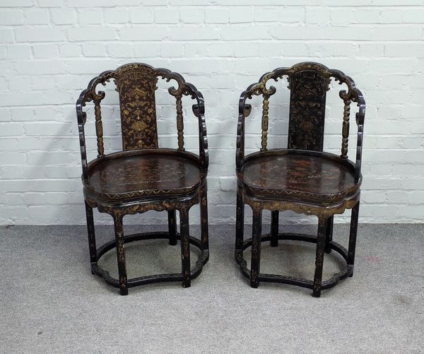 A pair of late 19th century Chinese black lacquer chinoiserie decorated side chairs, each with cloud shaped backs, solid splat and seat on six block s