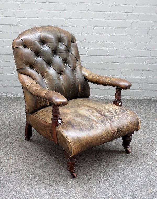 A Victorian mahogany framed open armchair with studded green leather upholstery on turned supports, 71cm wide x 92cm high.