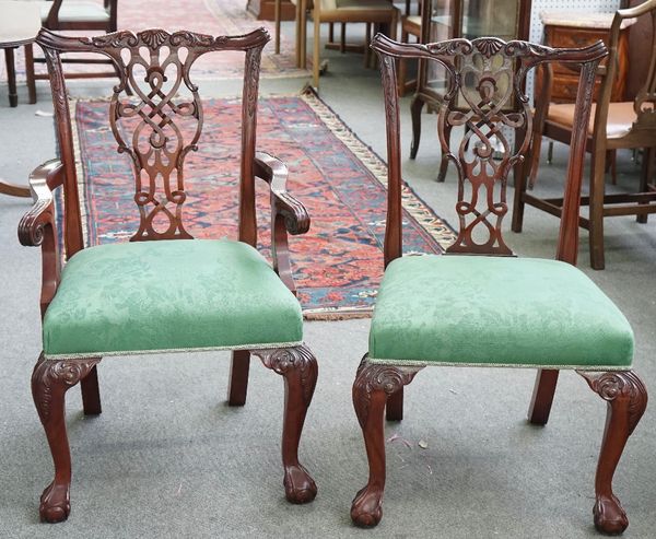 A set of twelve 18th century style mahogany dining chairs with pierced splat back on claw and ball feet, with pair of carvers, 1 a.f, (12).