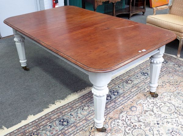 A Victorian mahogany dining table, the rounded rectangular top on later painted tapering octagonal supports, (alterations), 108cm wide x 182cm long.