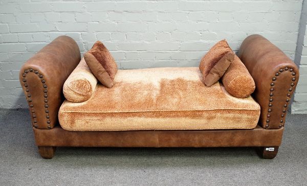 John Sankey; a modern studded brown leather upholstered day bed on tapering block supports, 165cm wide x 66cm high.