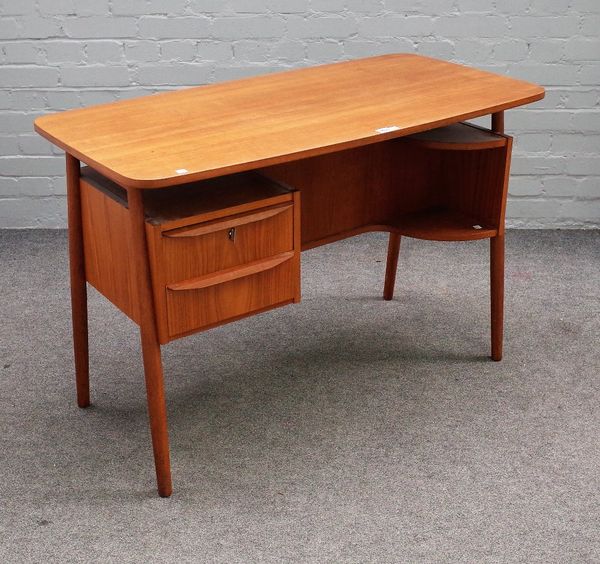 Gunnar Nielsen Tibergaard Denmark; a teak desk, circa 1970, with a pair of pedestal drawers and open shelves, on turned supports, 110cm wide x 72cm hi