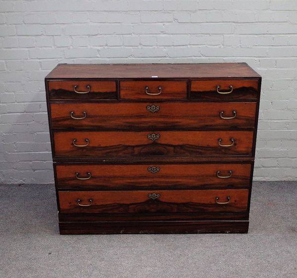 A Japanese softwood and hardwood dansu chest, of three short over four long drawers, on a plinth base, 119cm wide x 100cm high, (2).