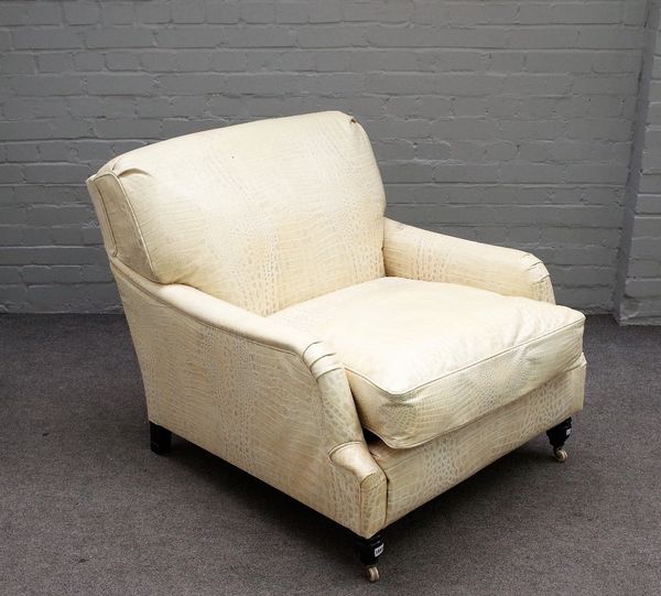 A cream leather faux crocodile skin upholstered easy armchair on turned ebonised supports, 90cm wide x 83cm high.