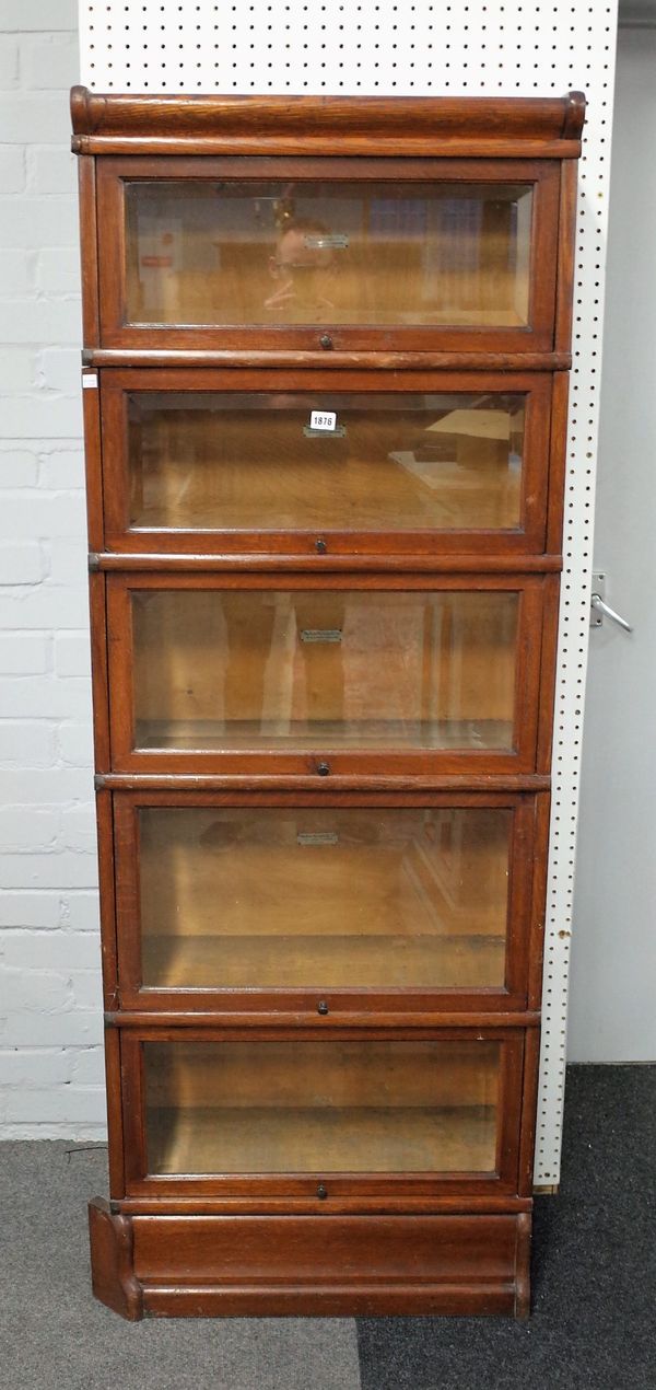 Globe Wernicke; a narrow oak five section bookcase with bevelled glazed doors, 65cm wide x 160cm high.