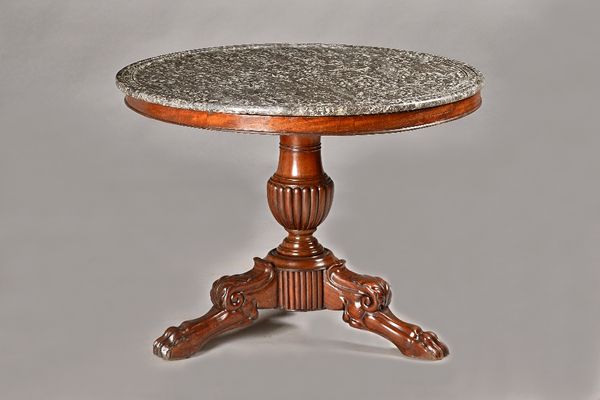 An early 19th century French gueridon, the dished circular marble top on a mahogany base with semi reeded baluster column and three paw feet, 98cm dia