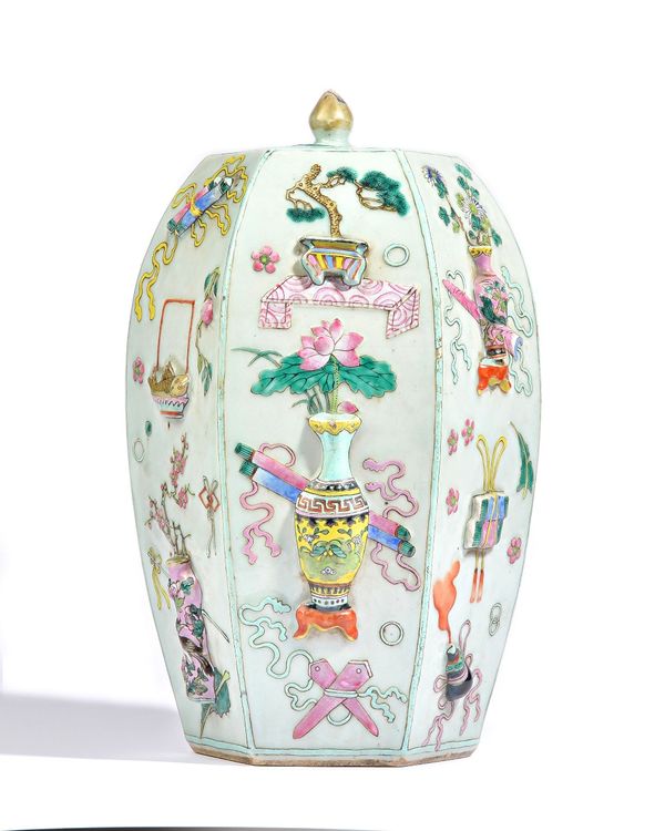 A Chinese famille-rose jar and cover, late 19th/early 20th century, of swollen hexagonal form, decorated in high relief with birds, flowers and object