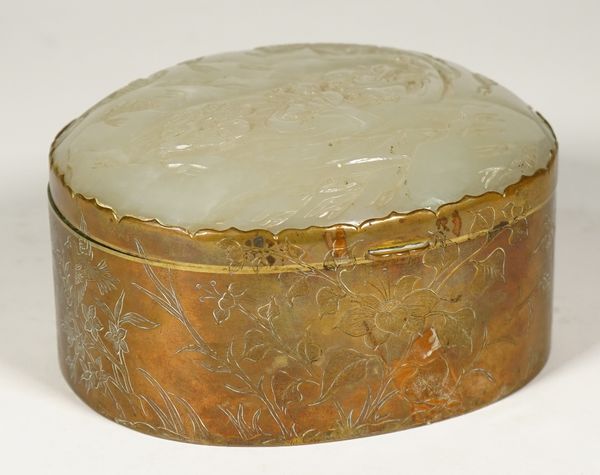 A Chinese jade mounted gilt-metal oblong jewel box, late 19th/early 20th century, the hinged cover inset with a pale celadon jade plaque, carved with