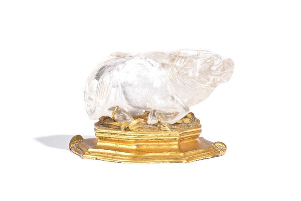 A Chinese rock crystal figure of a water buffalo, 19th century, carved in a recumbent pose on a European gilt-bronze base, buffalo 10cm. length.