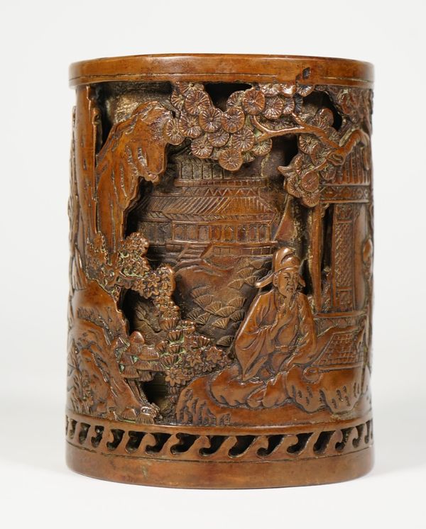 A Chinese bronze double-walled cylindrical brush pot, sixteen character Xuande mark but later, the outer wall cast with two seated figures playing go