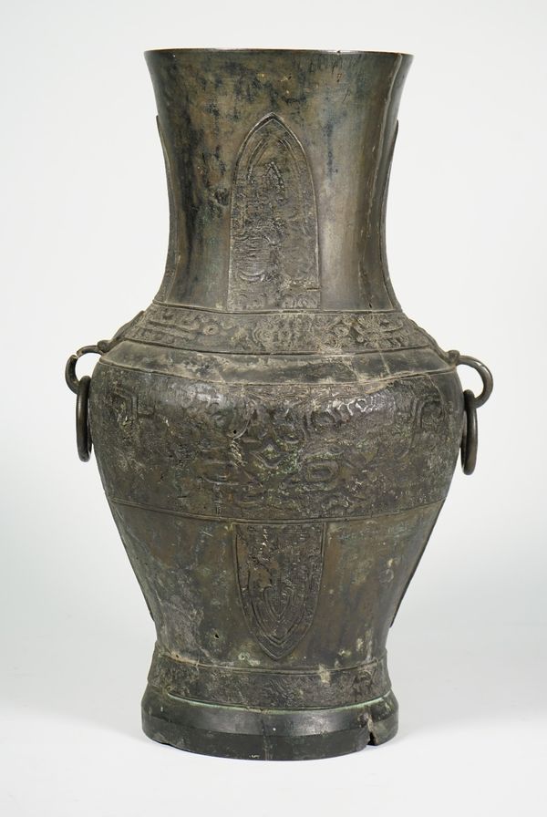 A large Chinese archaistic bronze two-handled vase, of baluster form set with mask and ring handles, the body decorated with  bands of taotie masks be