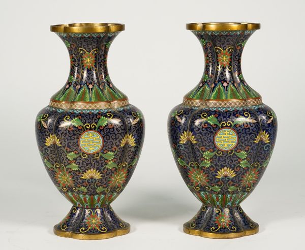 A pair of Chinese cloisonné vases, circa 1900, of quatrelobed baluster form, each worked with shou characters, lotus flowers and tendrils against a de