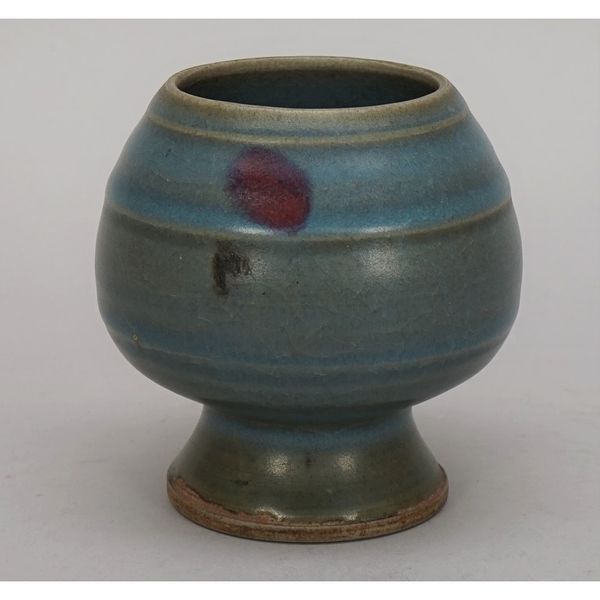 A Chinese junyao waterpot, bulbous form on spreading base, covered in a blue glaze with purple splashes, 10cm. high.