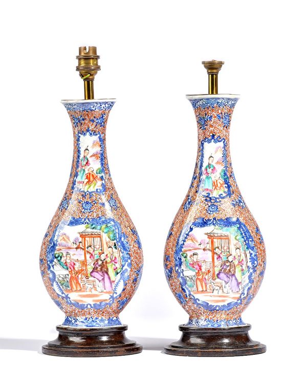 A pair of Chinese export mandarin palette vases, Qianlong, of flattened pear shaped each vase painted with four figurative panels against a Y-diaper g