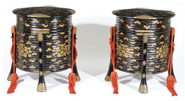 A pair of Japanese black lacquer storage boxes ( karabitsu), Meiji period, each of ribbed cylindrical form raised on three splayed supports with brass