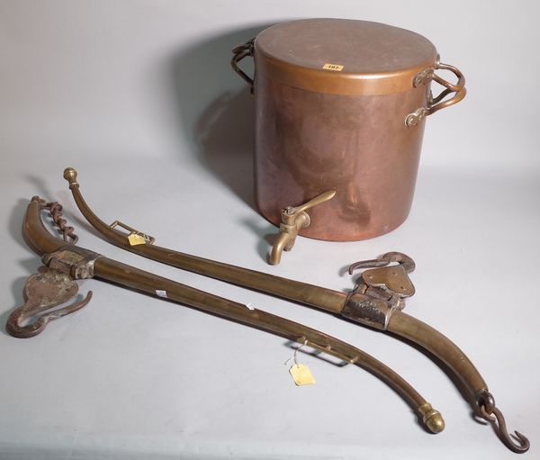 An early 20th century copper twin handled lidded urn with tap, 42cm wide x 53cm high and a pair of early 20th century brass horse hames, 88cm long, (3