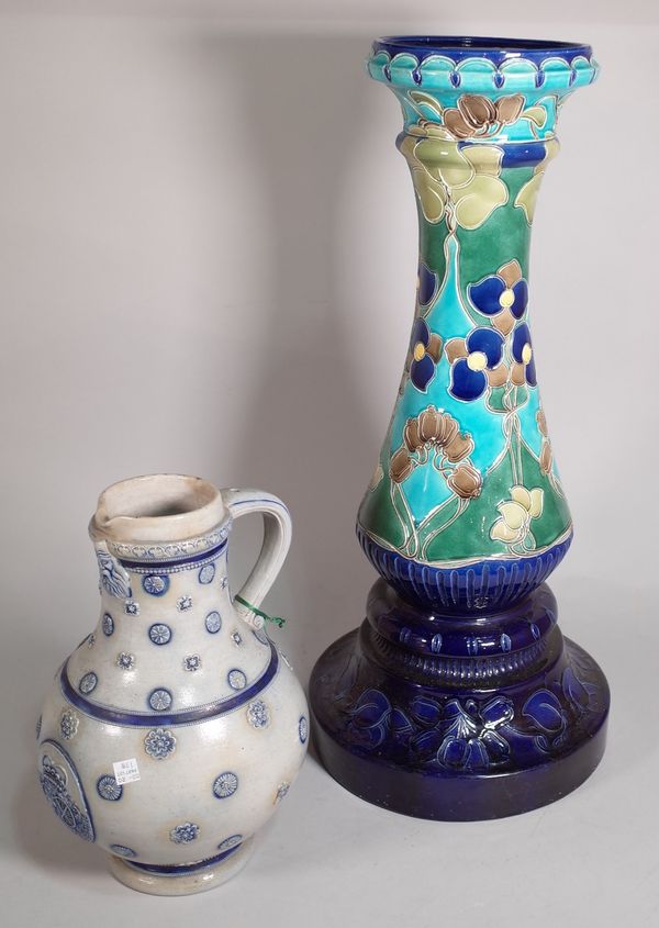 An early 20th century ceramic Art Noveau style jardiniere stand, 19cm wide x 67cm high and a German stoneware jug, 35cm high, (2).  B2