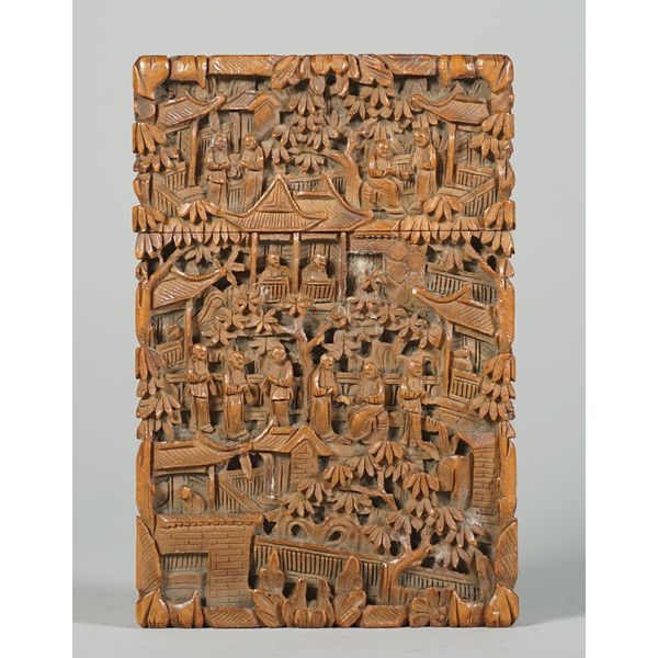 A Canton carved wood card case, late 19th century, of rectangular form, profusely carved with figures amongst trees and pavilions, 11.75cm high.