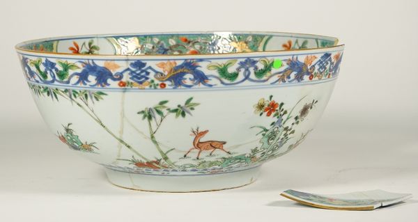 A Chinese famille-verte punch bowl, Kangxi, painted on the exterior with deer and crane amongst bamboo and rocks, the interior painted with birds, ins