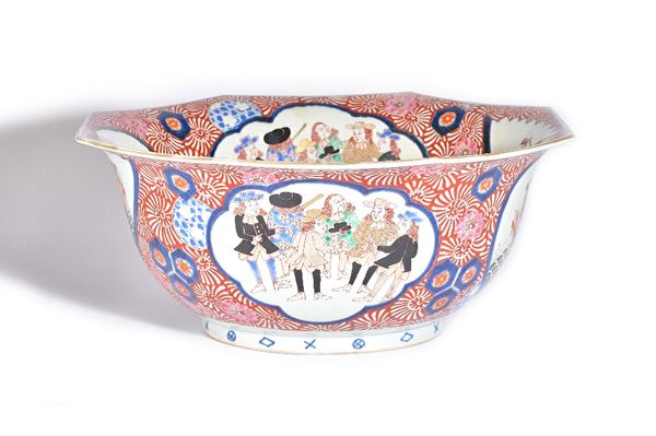 A large Japanese Imari `black ship' bowl, Meiji period, of octagonal form, painted on the interior and exterior with panels of Dutch ships alternating