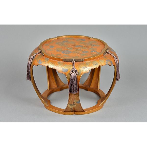 A good Japanese lacquer low table, Edo period, 19th century, of shaped circular form, decorated in gold and silver hiramaki-e and kirikane over a dens