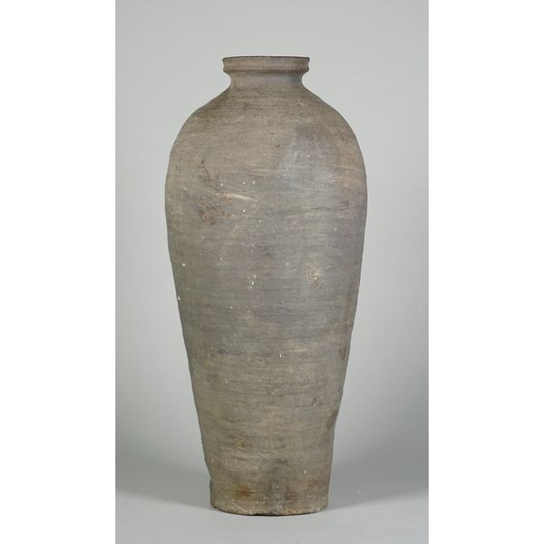 A tall Korean unglazed grey stoneware vase ( moebyeong), probably early Joseon dynasty, of slender form with short neck, 40.5cm. high.