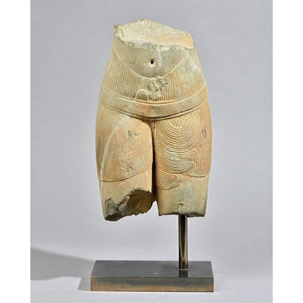 A Khmer sandstone torso, 11th/12th century, carved in the round, showing the lower stomach and thighs of a female figure, 37cm. high, on mount.