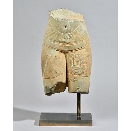 A Khmer sandstone torso, 11th/12th century, carved in the round, showing the lower stomach and thighs of a female figure, 37cm. high, on mount.