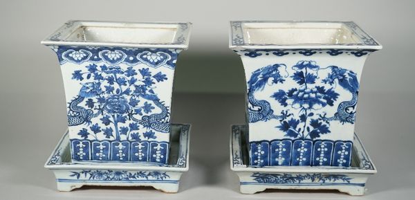 A near pair of Chinese blue and white porcelain jardinieres and stands, late 19th century, of square section, each jardiniere painted with two confron