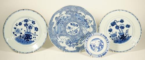 A Chinese blue and white plate, Qianlong, painted with a central panel of flowers and insects against a whorl pattern ground reserved with three ruyi-