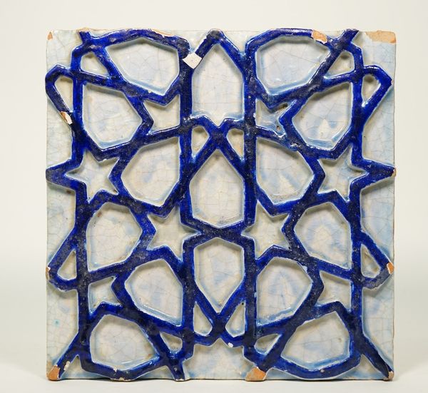 A large Multan pottery tile, Pakistan, late 19th/20th century, moulded in high relief with a cobalt blue stylised design against a pale blue ground, 3