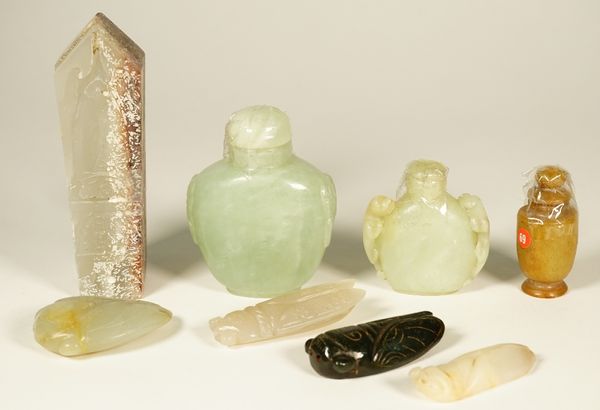 A group of Chinese jade carvings, comprising; an archaistic box and cover carved with a cicada, 11.5cm. length; four jade cicadas; three jade snuff bo