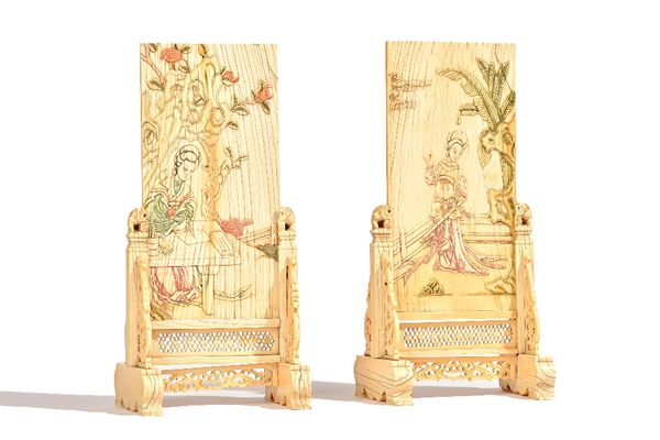 A pair of Chinese ivory table screens and stands, Qing dynasty, each rectangular panel carved and stained with a woman in a garden, the reverse with l