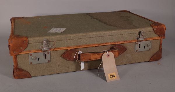 An early 20th century canvas and leather bound military suitcase, 63cm wide x 16cm high.  E2