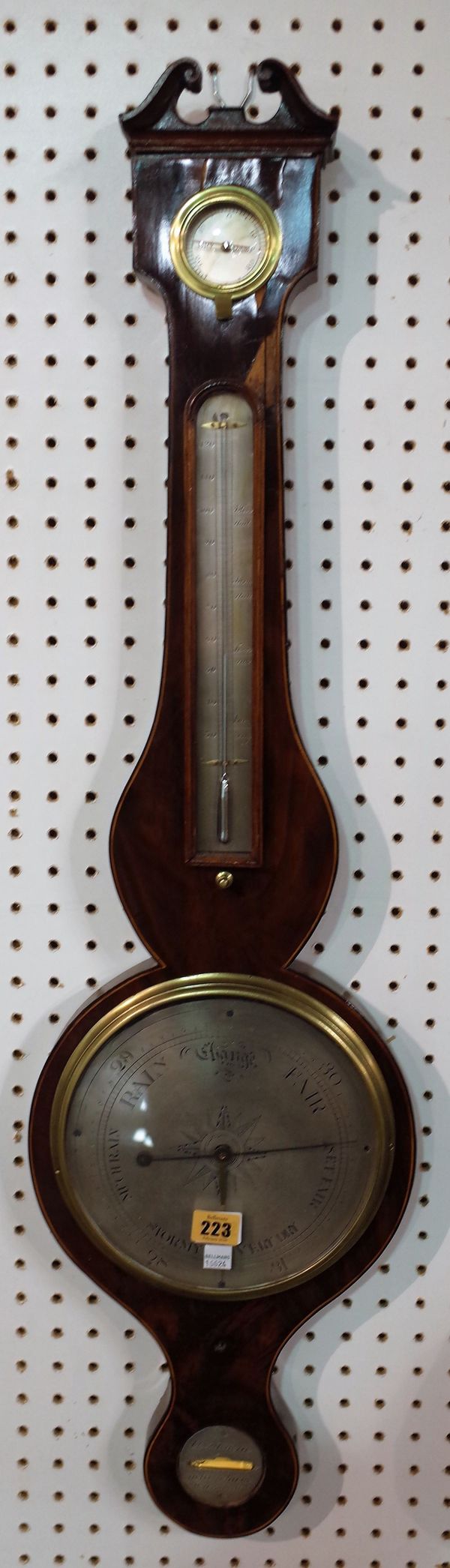 A Victorian mahogany wheel barometer by A. Pagan, Nottingham, with broken arch pediment, dry/ damp detector over a thermometer, 8.5 inch silvered dial