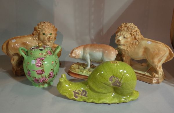 20th century ceramics, including; a pair of large Staffordshire type models of lions, a model of a pig, a green glazed terracotta snail, 17cm high and