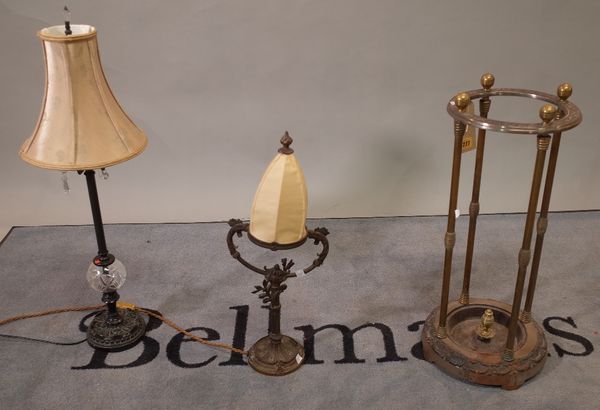 A 20th century brass and steel stick stand, 25cm wide x 64cm high and an early 20th century bronze table lamp, 52cm high and another similar, (3). D4