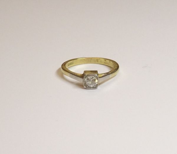 A gold and diamond single stone ring, mounted with a cushion shaped diamond within a square shaped setting, detailed 18 CT, ring size J, gross weight