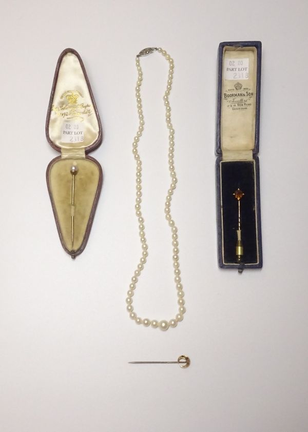 A cultured pearl stick pin, a ruby and diamond stick pin, with a crescent motif, a smoky quartz stick pin, two stick pin cases and a single row neckla