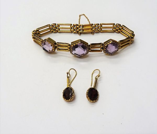 A gold and amethyst bracelet, in a three row bar and oval link design, mounted with three hexagonal cut amethysts, on a snap clasp, detailed 9 C, fitt