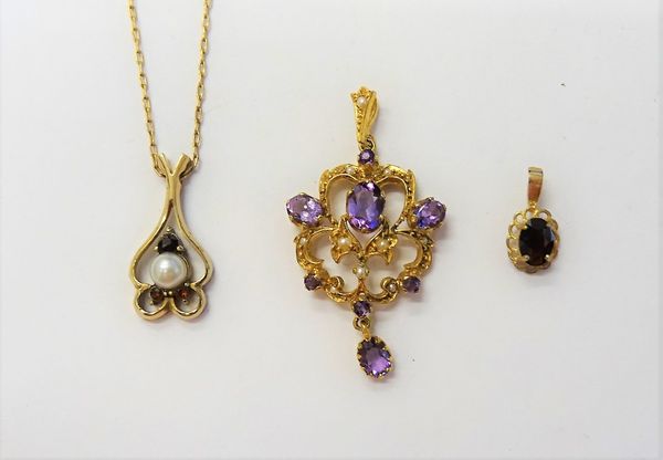 A 9ct gold, amethyst and seed pearl set pendant, in a scroll pierced openwork design, a 9ct gold, garnet and cultured pearl pendant, with a gilt metal